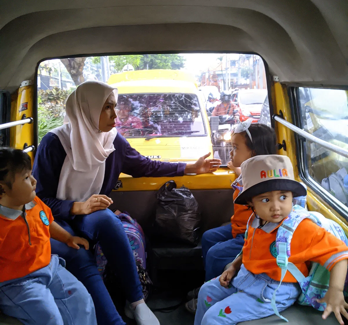 AULIA Preschool students learning to ride public transport with their teacher